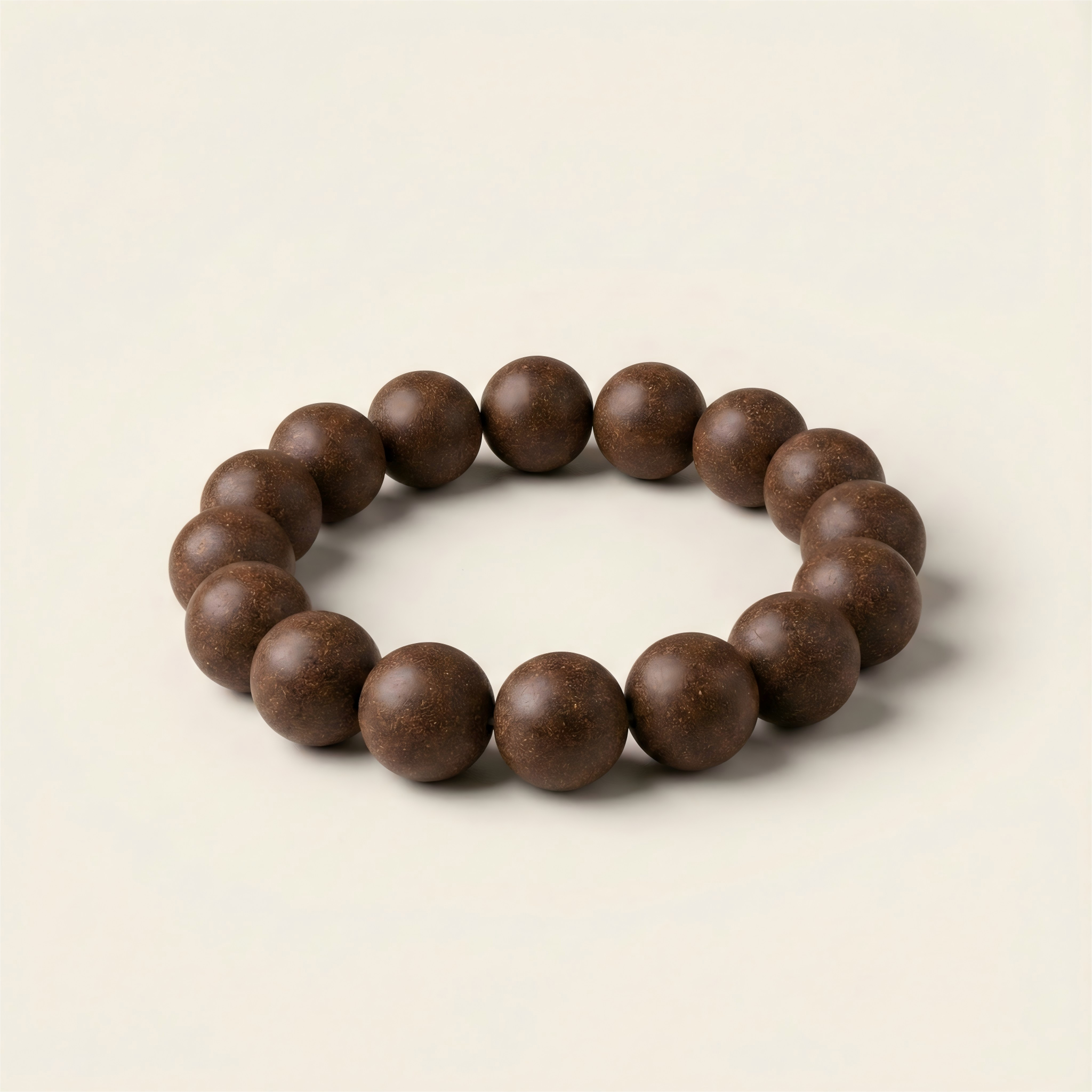 Hidden Scent handmade Golden Ginseng and Agarwood herbal energy bracelet for vitality boost on neutral background.